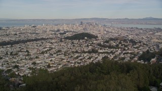 5K aerial stock footage tilt from hillside homes and Mount Sutro forest to reveal skyscrapers in Downtown San Francisco, California Aerial Stock Footage | AXSF06_037