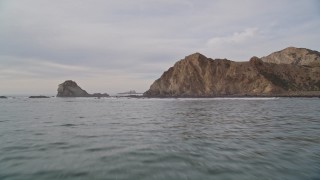 5K aerial stock footage of flying low over ocean between rock formation and coastal cliffs, Bolinas, California Aerial Stock Footage | AXSF06_062