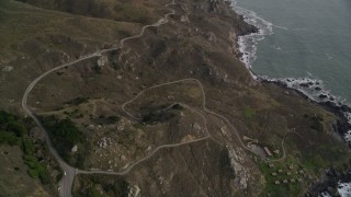 5K aerial stock footage video of following Highway 1 coastal road winding above cliffs, Marin County, California Aerial Stock Footage | AXSF06_071