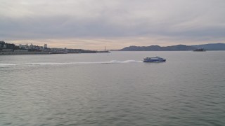 AXSF06_084 - 5K aerial stock footage track a ferry cruising the bay, revealing Coit Tower, San Francisco, California