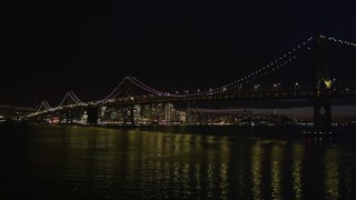 5K aerial stock footage low altitude approach to the Bay Bridge and downtown skyline, San Francisco, California, night Aerial Stock Footage | AXSF07_004