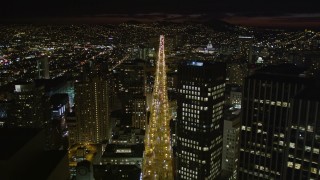 5K aerial stock footage of flying over Market Street past skyscrapers in Downtown San Francisco, California, night Aerial Stock Footage | AXSF07_008