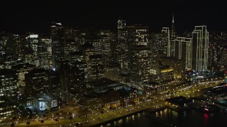 5K aerial stock footage of tilting from the bay, revealing skyscrapers in Downtown San Francisco, California, night Aerial Stock Footage | AXSF07_033