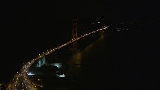 5K aerial stock footage tilt from bird's eye of freeway interchange to reveal Golden Gate Bridge, San Francisco, California, night Aerial Stock Footage | AXSF07_038