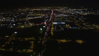 AXSF07_098 - 5K aerial stock footage follow I-880 toward O.co Coliseum and Oracle Arena, tilt down, Oakland, California, night