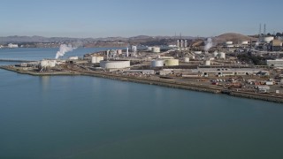 AXSF08_016 - 5K aerial stock footage of flying by ConocoPhillips Oil Refinery, seen from San Pablo Bay, Rodeo, California