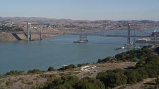 AXSF08_025 - 5K aerial stock footage of flying over hill, revealing Carquinez Bridge, Carquinez Strait, Vallejo, California