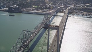 AXSF08_026 - 5K aerial stock footage of tilting from a docked ship at California Maritime Academy to reveal and fly over Carquinez Bridge, California