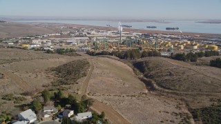 5K aerial stock footage of flying over tract homes, revealing Valero Oil Refinery, Benicia, California Aerial Stock Footage | AXSF08_032