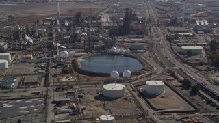 5K aerial stock footage of flying by pond at Tesoro Golden Eagle Refinery, Pacheco, California Aerial Stock Footage | AXSF08_056