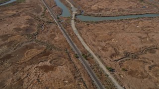 5K aerial stock footage of a reverse view of train tracks and Waterfront Road, Martinez, California Aerial Stock Footage | AXSF08_058