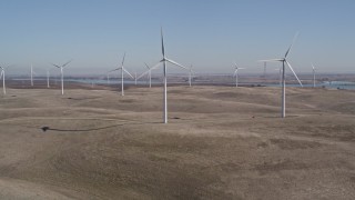 5K aerial stock footage tilt from hills to reveal Shiloh Wind Power Plant windmills, Montezuma Hills, California Aerial Stock Footage | AXSF08_067