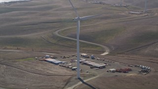 5K aerial stock footage of cargo containers and Shiloh Wind Power Plant windmill, Montezuma Hills, California Aerial Stock Footage | AXSF08_071