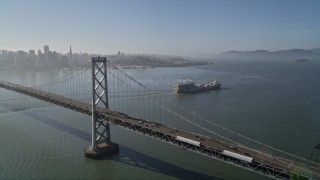 5K aerial stock footage of cargo ship, Bay Bridge, reveal Downtown San Francisco skyline, California Aerial Stock Footage | AXSF09_062