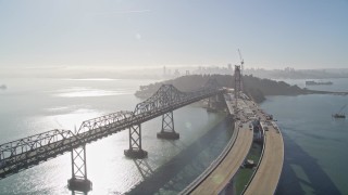 AXSF09_064 - 5K aerial stock footage of flying by the Bay Bridge, new span under construction, San Francisco, California