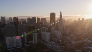 5K aerial stock footage of flying by downtown skyscrapers and Transamerica Pyramid, Downtown San Francisco, California at sunset Aerial Stock Footage | AXSF10_007