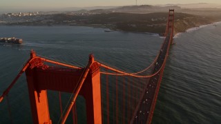 5K aerial stock footage of flying over Golden Gate Bridge, reveal cargo ship, San Francisco, California, sunset Aerial Stock Footage | AXSF10_033