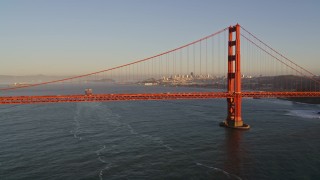 5K aerial stock footage cargo ship sailing the bay, Golden Gate Bridge, skyline in the distance, San Francisco, California, sunset Aerial Stock Footage | AXSF10_034