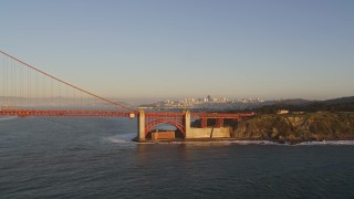 5K aerial stock footage of flying by Golden Gate Bridge with view of Downtown San Francisco, California, sunset Aerial Stock Footage | AXSF10_035