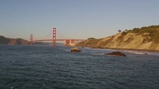 5K aerial stock footage descend to rock formations, approach Golden Gate Bridge, San Francisco, California, sunset Aerial Stock Footage | AXSF10_037