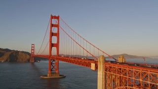 AXSF10_038 - 5K aerial stock footage low approach and ascend over the Golden Gate Bridge, San Francisco, California, sunset