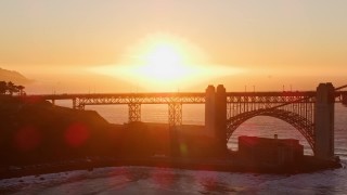 5K aerial stock footage of the Presidio side of Golden Gate Bridge and setting sun, San Francisco, California Aerial Stock Footage | AXSF10_050