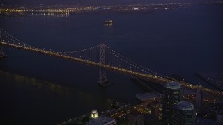 5K aerial stock footage approach and tilt to the Bay Bridge from Downtown San Francisco, California, night Aerial Stock Footage | AXSF10_099