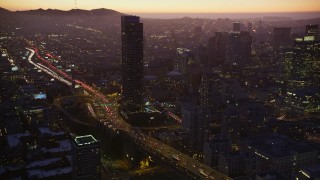 5K aerial stock footage tilt from Bay Bridge traffic, revealing freeway and skyscraper, South of Market, San Francisco, California, twilight Aerial Stock Footage | AXSF10_100