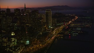 5K aerial stock footage tilt from heavy traffic on the Bay Bridge, reveal Downtown San Francisco, California, twilight Aerial Stock Footage | AXSF10_109