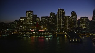 5K aerial stock footage of the Ferry Building and towering skyscrapers in Downtown San Francisco, California, night Aerial Stock Footage | AXSF10_114