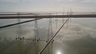 5K aerial stock footage of flying by a row of power lines and marshlands, Sunnyvale, California Aerial Stock Footage | AXSF11_023