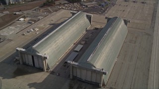 5K aerial stock footage tilt to reveal Hangar Two, Hangar Three at Moffett Field military base, Mountain View, California Aerial Stock Footage | AXSF11_053