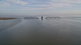 AXSF12_065 - 5K aerial stock footage of flying by a bridge spanning San Francisco Bay, California