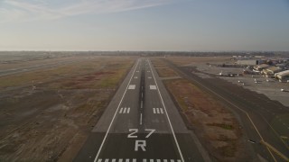 5K aerial stock footage tilt from golf course to reveal and approach Oakland International Airport, California Aerial Stock Footage | AXSF12_089