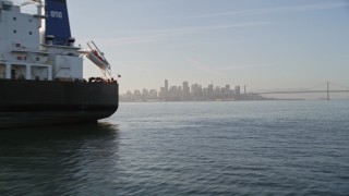 AXSF13_003 - 5K aerial stock footage flyby oil tanker on San Francisco Bay, reveal Downtown San Francisco skyline, California