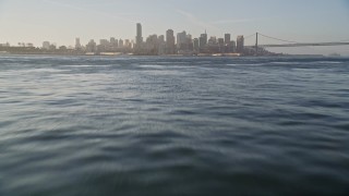 5K aerial stock footage fly low over bay toward downtown, tilt to the water, Downtown San Francisco, California Aerial Stock Footage | AXSF13_006