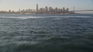 5K aerial stock footage of flying low over bay, tilt up to reveal Downtown San Francisco skyline, California Aerial Stock Footage | AXSF13_007