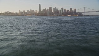 5K aerial stock footage fly low over Bay to approach city skyline, tilt down to the water, Downtown San Francisco, California Aerial Stock Footage | AXSF13_008