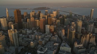 5K aerial stock footage approach skyscrapers and tilt to buildings below in Downtown San Francisco, California, sunset Aerial Stock Footage | AXSF14_008