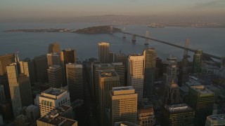 5K aerial stock footage tilt to reveal and fly over skyscrapers in Downtown San Francisco, California, and approach the Bay Bridge, twilight Aerial Stock Footage | AXSF14_009