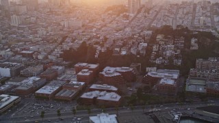 AXSF14_030 - 5K aerial stock footage tilt from North Beach apartments, reveal iconic Coit Tower, San Francisco, California, sunset