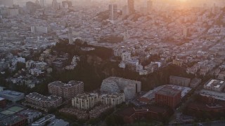 AXSF14_031 - 5K aerial stock footage flying by Coit Tower and North Beach apartment buildings, San Francisco, California, sunset