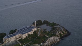 5K aerial stock footage of the main buildings and lighthouse on Alcatraz island, San Francisco, California, twilight Aerial Stock Footage | AXSF14_036