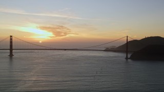 5K aerial stock footage of flying by the famous Golden Gate Bridge with view of setting sun, San Francisco, California, sunset Aerial Stock Footage | AXSF14_038