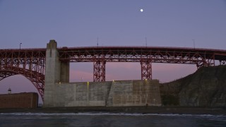 5K aerial stock footage of the moon above Presidio cliffs, reveal the Golden Gate Bridge, San Francisco, California, twilight Aerial Stock Footage | AXSF14_051