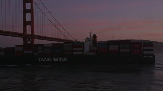 5K aerial stock footage orbit cargo ship and reveal Golden Gate Bridge, San Francisco, California, twilight Aerial Stock Footage | AXSF14_064