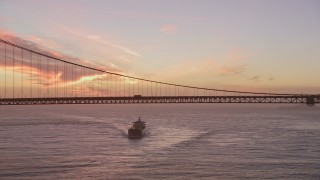 AXSF14_069 - 5K aerial stock footage a view of an oil tanker approaching the Golden Gate Bridge, San Francisco, California, twilight