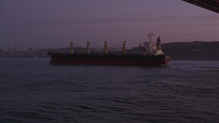 5K aerial stock footage approach oil tanker sailing under Golden Gate Bridge, San Francisco, California, twilight Aerial Stock Footage | AXSF14_072