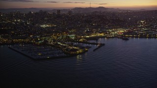 5K aerial stock footage of flying away from Pier 39. and Fisherman's Wharf in San Francisco, California, twilight Aerial Stock Footage | AXSF14_093