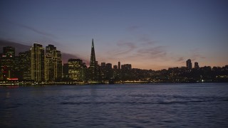 5K aerial stock footage low flyby of Transamerica Pyramid and Downtown San Francisco skyline, reveal the Ferry Building, California, twilight Aerial Stock Footage | AXSF14_103